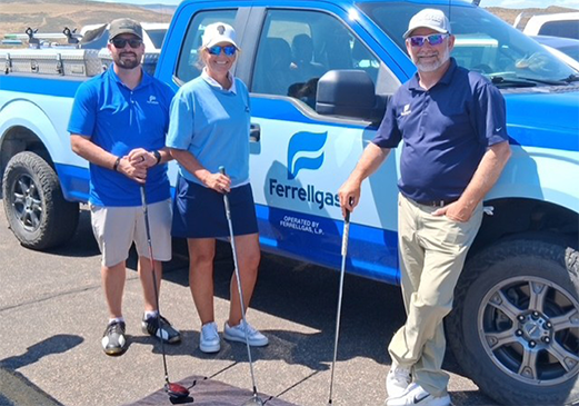 Ferrellgas employees standing near a truck ready to golf.