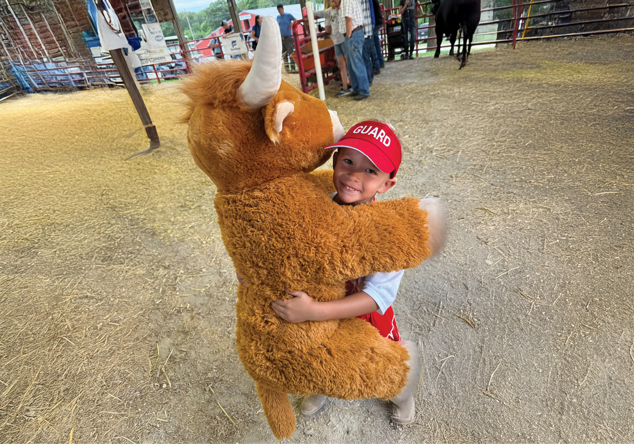Young boy holds a prize stuffed animal at the Rock Island County Fair.