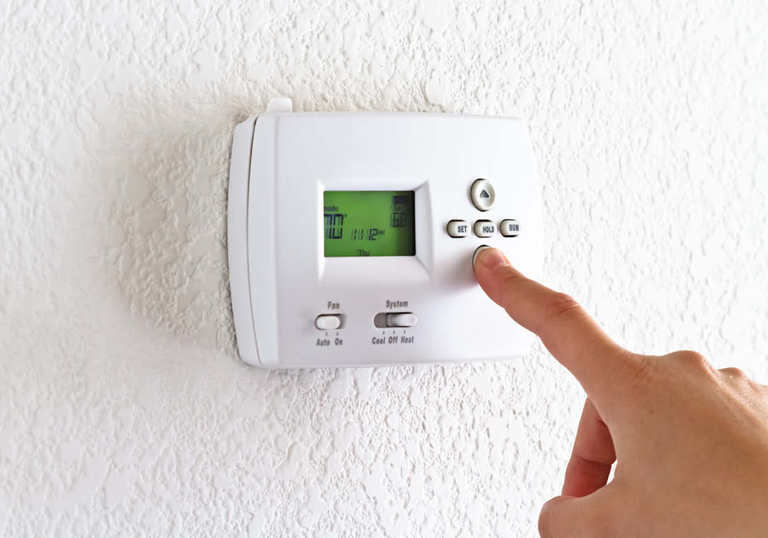 Close-up photo of a home’s digital thermostat.