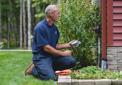 Ferrellgas professional performs a safety inspection outside of a home.