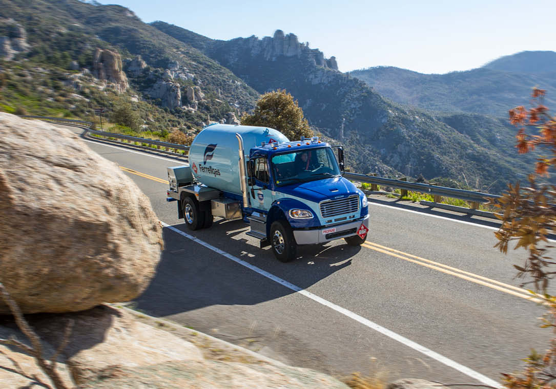 Ferrellgas bobtail delivery truck driving along a scenic mountain route.